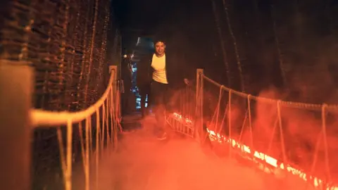 Layered Reality A person in the War of the Worlds experience with a virtual reality headset