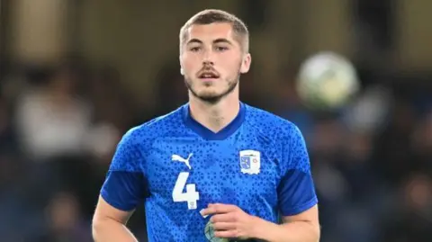 Barrow midfielder Dean Campbell wearing the club's away kit