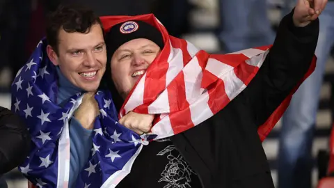 Getty Images Two Scotland football fans wrapped in a USA flag.