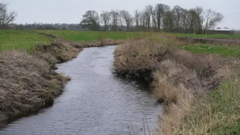 PA Media The section of the River Wyre where a body was recovered