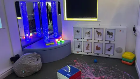 Holly Rattley A sensory room at a nursery with neon lights and children's toys