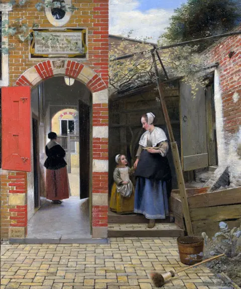 Getty Images A 17th-century painting from the Dutch golden age showing a woman and small child standing in a courtyard. A second woman is standing in an arched passageway.