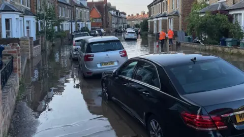 Water flooding a street in Oxford.