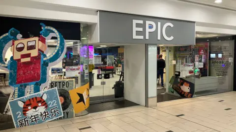 Mark Ansell/BBC The frontage of the youth centre which has the word 'EPIC" in white letter on the top and a big image of a red robot on the side.