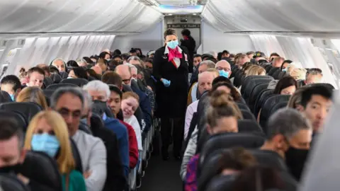 Getty Images A plane carrying mask-wearing passengers between Sydney and Adelaide in 2020