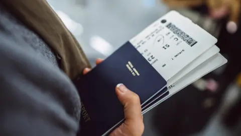 Getty Images Woman holding passport