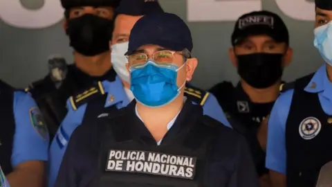 Reuters Former Honduras President Juan Orlando Hernandez looks on at the Police Special Forces after being detained by members of the Honduras National Police in Tegucigalpa, Honduras February 15, 2022