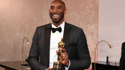 AFP/Getty Kobe Bryant with an Oscar