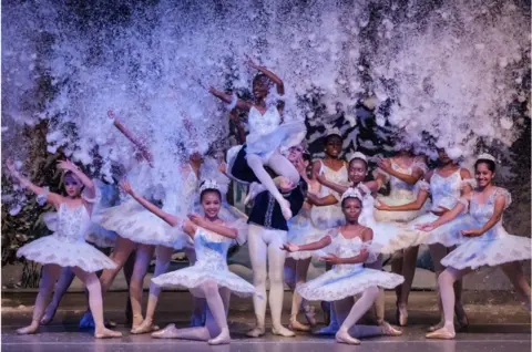 AFP Young girls wearing white performing ballet.