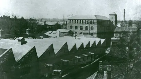 Wiltshire Council Old photograph of several old buildings with sloped roofs.