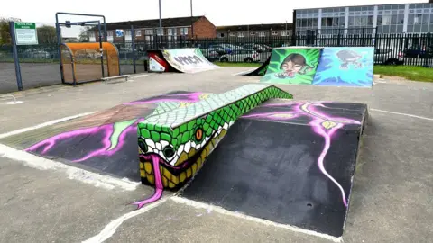 The newly refurbished skate park with ramps painted with colourful graffiti style graphics