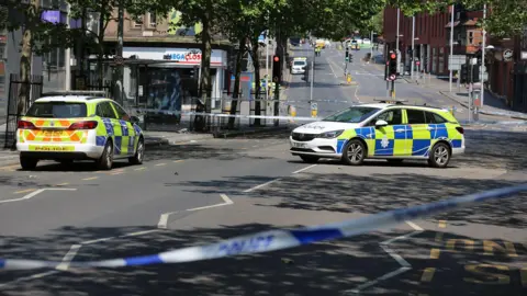 Nottinghamshire Police Police vehicles and cordons in Milton Street where the Valdo Calocane had attempted to run over three people in a van, after fatally stabbing two teenage Barnaby Webber, 19, Grace O'Malley-Kumar, 19, and Ian Coates.