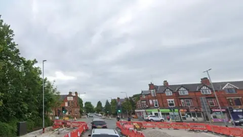 Works at the junction of Barton Road and Kingsway, in Stretford, with pavements cordoned off and excavated roads.