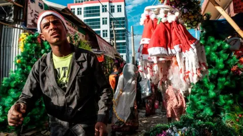 AFP A Christmas stall holder in Mekelle, Ethiopia - January 2020