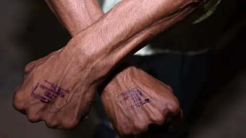 Getty Images A stamp on a man's hand