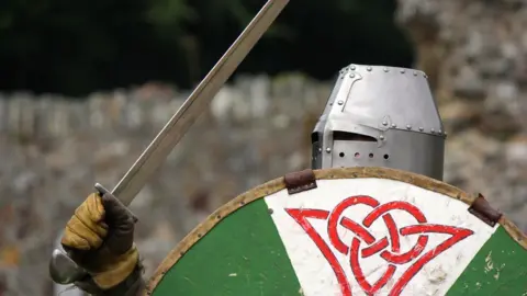 Historical re-enactor with sword and shield