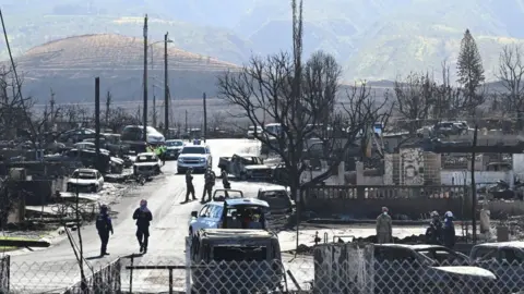 Getty Images Search and Rescue members conduct operations in fire damaged areas on Friday August 18, 2023 in Lahania, HI. The death toll continues to rise for the fires on Maui.