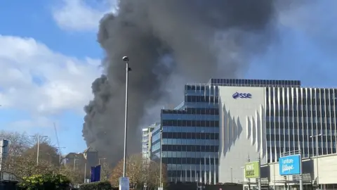 Paul Hunsdon black smoke billowing from building