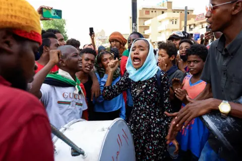 Reuters Protesters shout slogans during a rally against military rule, following the last coup and to commemorate the 3rd anniversary of demonstrations in Khartoum North, Sudan July 1, 2022.