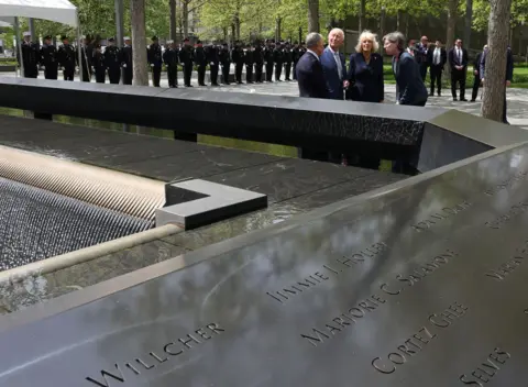 AFP via Getty Images Britain's King Charles III and Queen Camilla visit the 9/11 Memorial alongside former New York mayor Michael Bloomberg (L) and Beth Hillman, CEO of the 9/11 Memorial and Museum, in New York on April 29, 2026. 