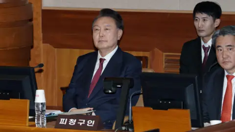 BBC/Hosu Lee Yoon Suk Yeol (left) in court