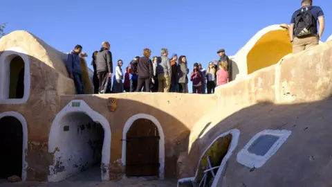 Getty Images Tourists at Ksar Haddada in Tunisia where part of the Star Wars series was filmed