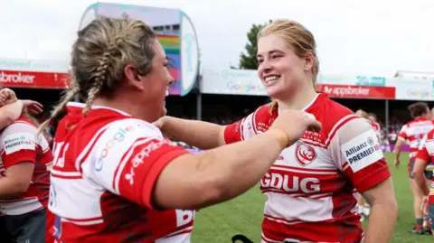 Kelsey Jones (left) and Bethan Lewis (right) hug after winning the PWR title