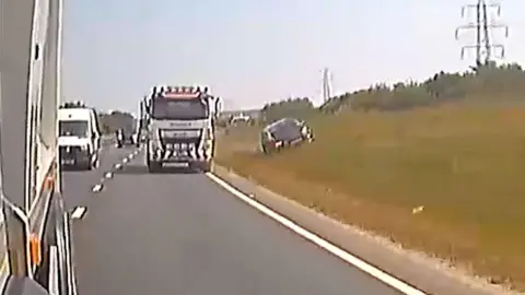 Operation Snap A dashcam image showing a car mounting a grass verge off a dual carriageway. 