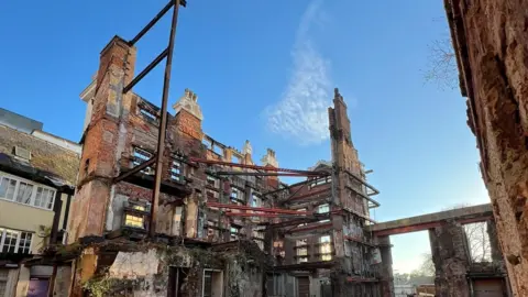 The former Royal Clarence Hotel in Exeter. The building is damaged and has temporary steelwork through the centre. 