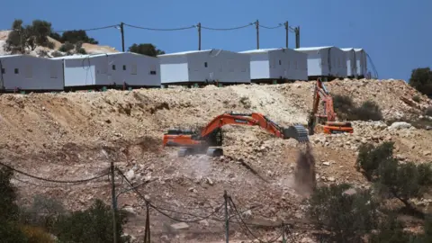 EPA Israeli excavators prepare land for the construction of the new settlement of Mevo Dotan, near the Palestinian city of Jenin, in the north of the occupied West Bank (13 July 2026)