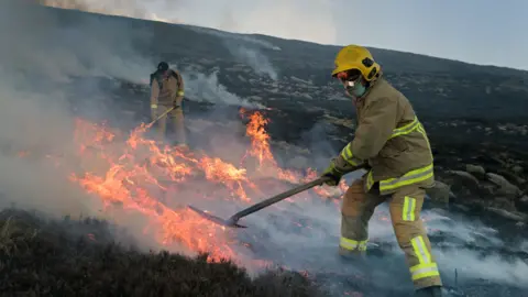 Getty Images/ Charles McQuillan Firefighters