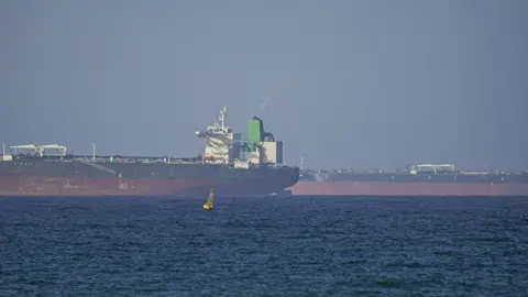 Anadolu via Getty Images A ship waits to pass through the Strait of Hormuz following the two-week temporary ceasefire between the US and Iran