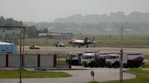 PTI Screen grab of a video that shows the jet being towed away to the Maintenance Repair and Overhaul (MRO) facility at Thiruvananthapuram airport