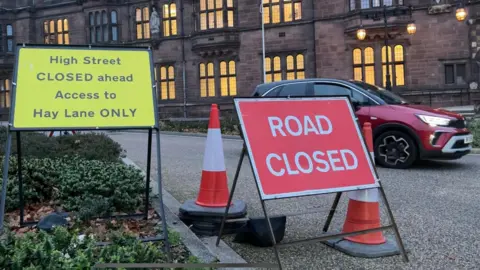 Sign showing road closed outside Coventry City Council's headquarters.