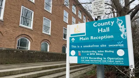 A sign for County Hall, the headquarters of Devon County Council