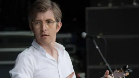 Gareth Malone playing a guitar