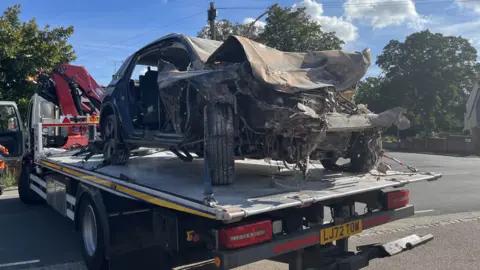 Charlie Jones/BBC A damaged car