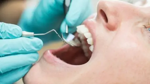 Woman having teeth checked