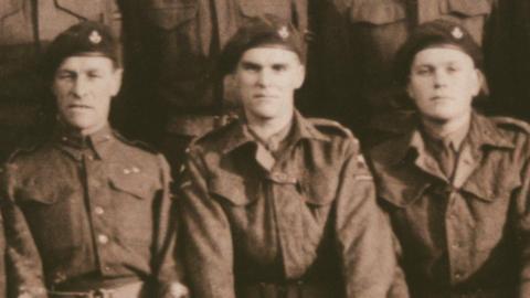 A sepia image of Den Brotheridge in uniform with some of his comrades 