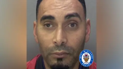Mohammed Alazawi's police mugshot. He is staring into the camera. He has a stubble around his top lop with a goatee beard. He has dark, short hair and brown eyes. 