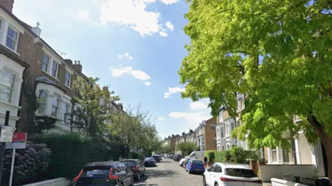A general view of Lena Gardens in Hammersmith with rows of houses on either side of the street. 