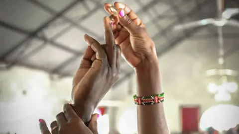 woman putting a wedding ring on her husband's finger