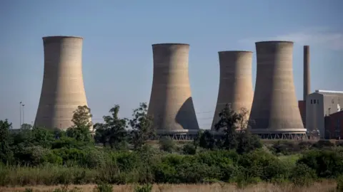 Getty Images The towers of the coal-fired Rooiwal Power Station are seen on the outskirt of Pretoria.