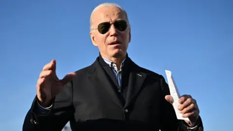 Getty Images US President Joe Biden speaks about the American prisoners in Venezuela before departing from Milwaukee Mitchell International Airport in Milwaukee, Wisconsin, on December 20, 2023, as he returns to the White House.