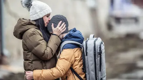 Getty Images A woman and child refugee