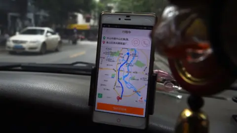 AFP Didi Chuxing app in a car