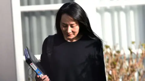 AFP via Getty Images Meng Wanzhou leaves her Vancouver home to attend British Columbia Supreme Court