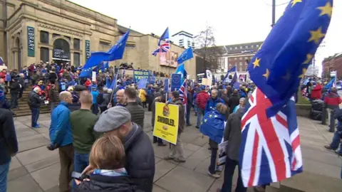 People rallying in front of Leeds Art Gallery