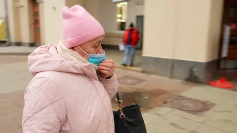 Women in a pink coat and hat