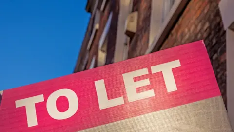 Getty Images To Let sign in front of a building.